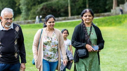 Family exploring the gardens in spring at Sizergh Castle, Cumbria